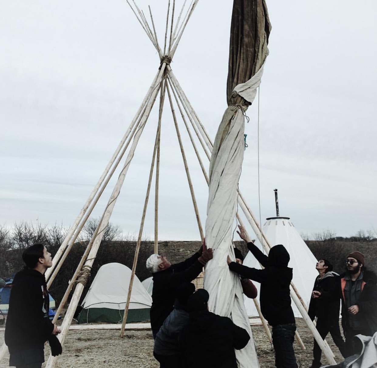 Setting up the tipi at IIYC camp. Photo credit: Luis Raul
