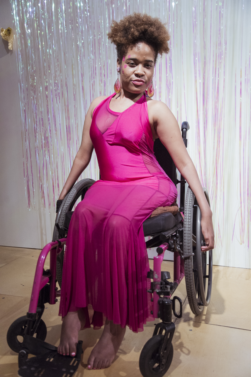 Dee Rae Glass rocks a hot pink dress that matches her wheelchair, while stylishly going barefoot. Photo credit Kiam Marcelo Junio.