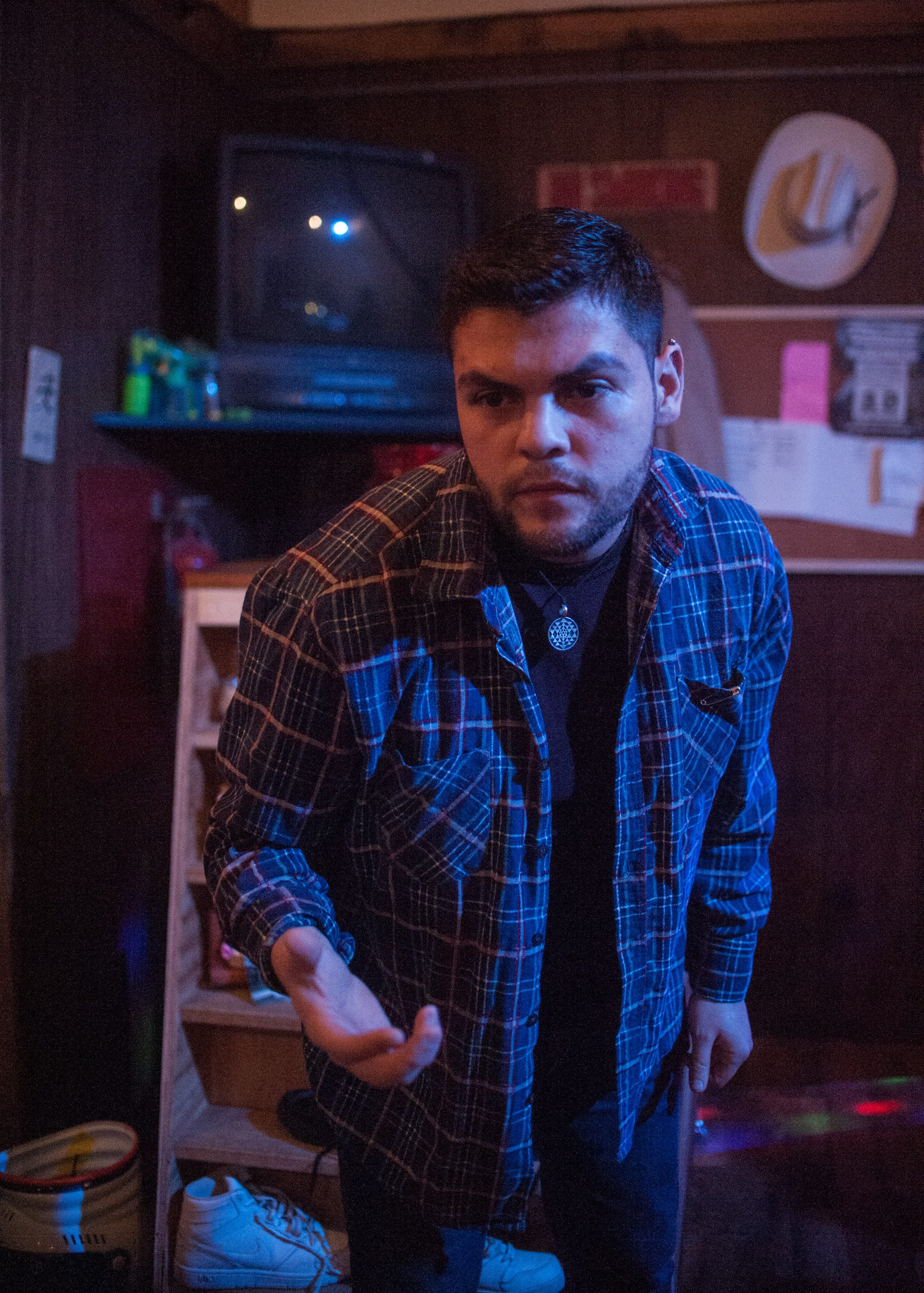 Anthony Soto leans foward, with his right hand outstretched in a scene from "Meet Juan(ito) Doe." Photo by William Camargo. 
