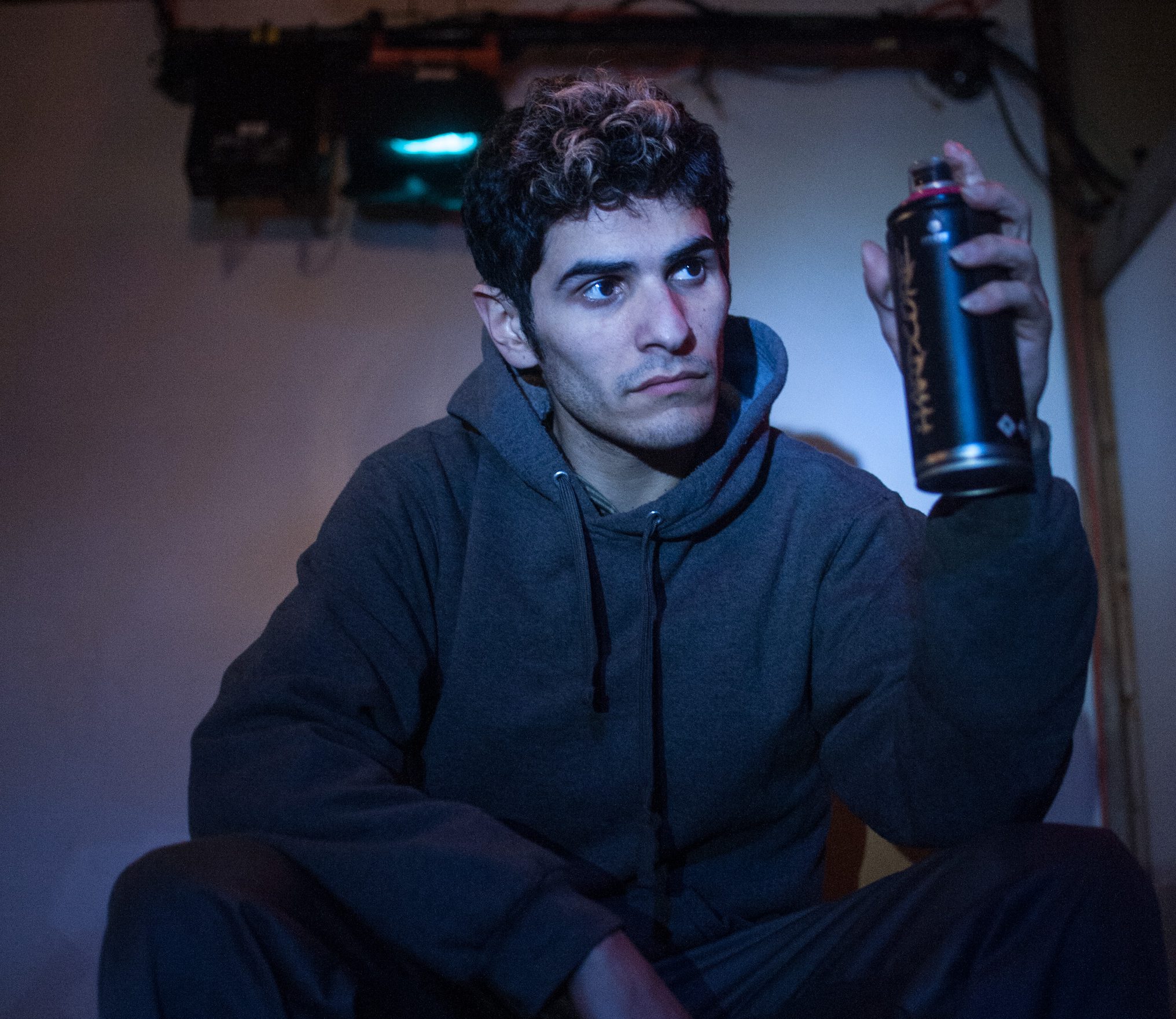 Nicolas Del Valle Jr. holds a can of spray in a monologue from "Meet Juan(ito) Doe." Photo by William Camargo.