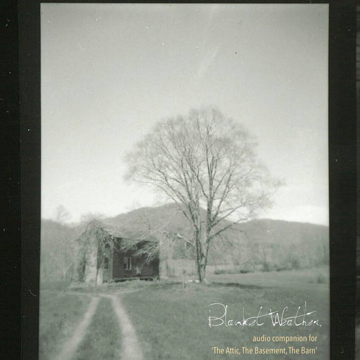 The album cover for “Blanket Weather.” The cover is square, with black and dark grey strips down the left and right sides. In the center is a low-saturation photograph of a rural scene: car tracks worn through a field toward an old farmhouse and a leafless tree, with a mountain in the background. Superimposed text reads: “Blanket Weather” and “audio companion for ‘The Attic, The Basement, The Barn.’” Courtesy of the artist.