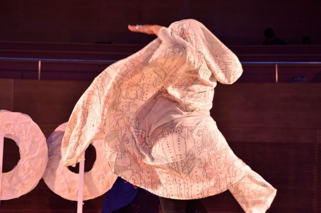 Image from "Ma(s)king Her" by Honey Pot Performance at Pritzker Pavilion, Millennium Park, Chicago, April 14–16, 2016 . Featuring Abra Johnson as Wonder in headdress and costume, and "Oracle" sculptures, all designed by D. Denenge Akpem (featuring textile by Euzhan Sims). Image credit: Tonika Johnson.