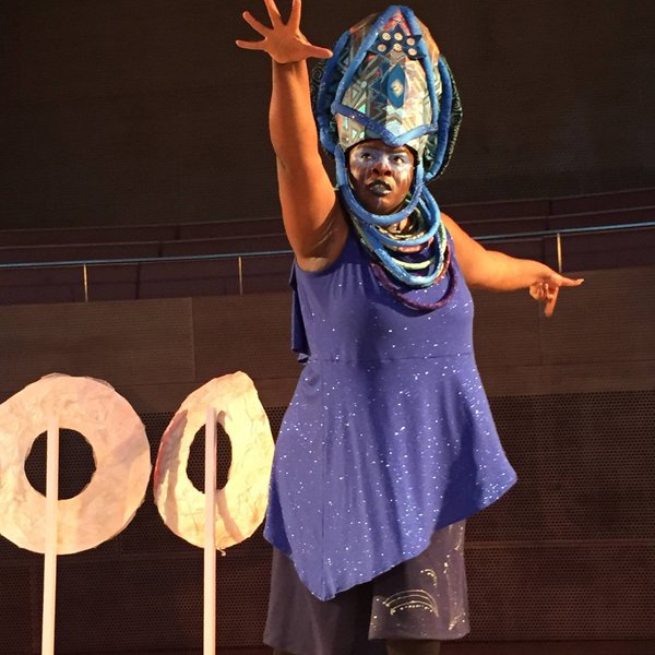 Image from "Ma(s)king Her" by Honey Pot Performance at Pritzker Pavilion, Millennium Park, Chicago, April 14–16, 2016 . Featuring "Oracle" sculptures and Abra Johnson as Wonder in headdress, both designed by D. Denenge Akpem (featuring textile by Euzhan Sims and costume by Jane Bagnall). Image credit: Lani Montreal.
