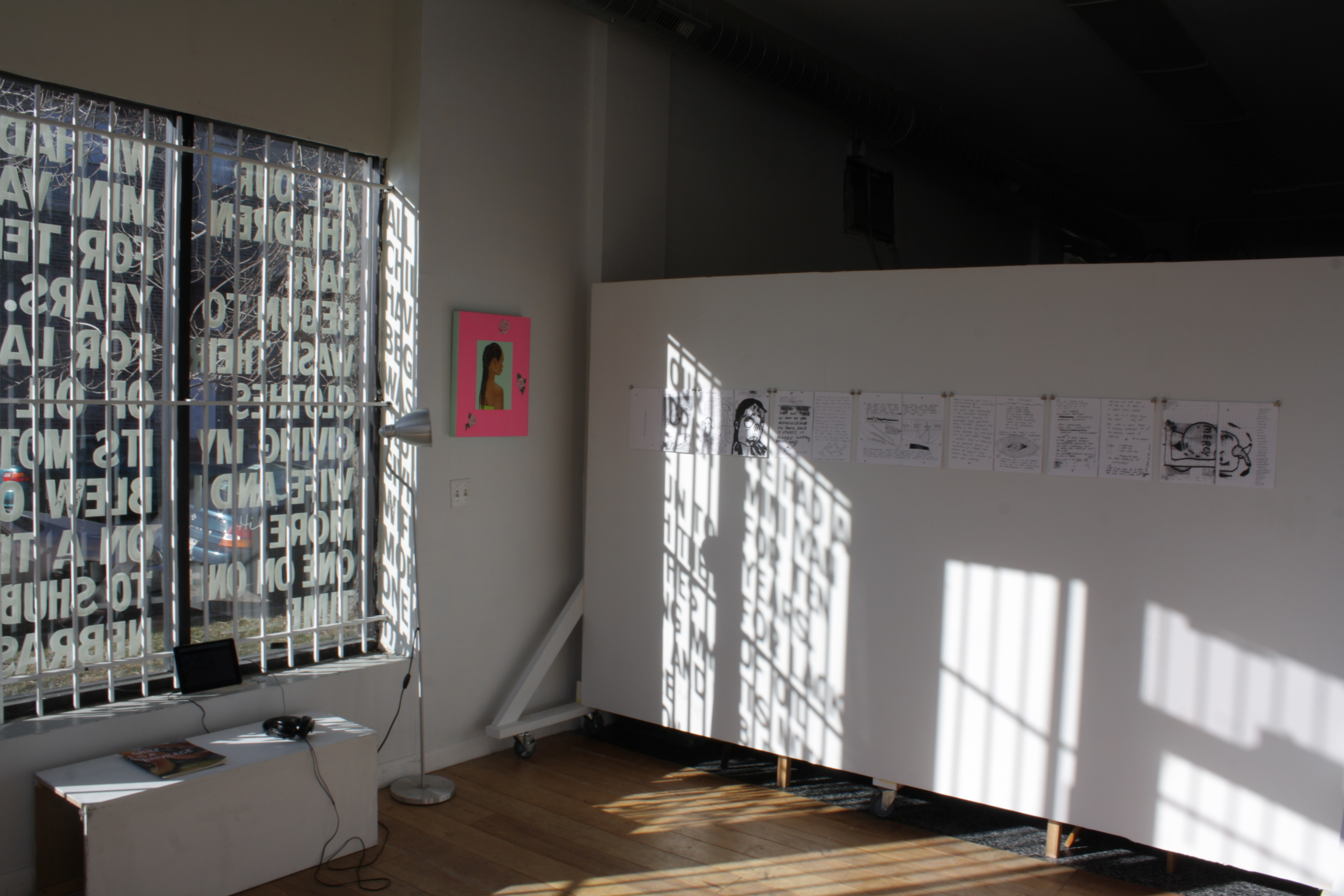 An installation view of the recently closed show at Hume, "Feeling Pink Like My Insides." Light streams through a window covered by letter that make up part of a semi-permanent installation by Alberto Aguilar. On the walls hang works by Ari Brielle and Caroline Hicks. Photo by Hannah Siegfried
