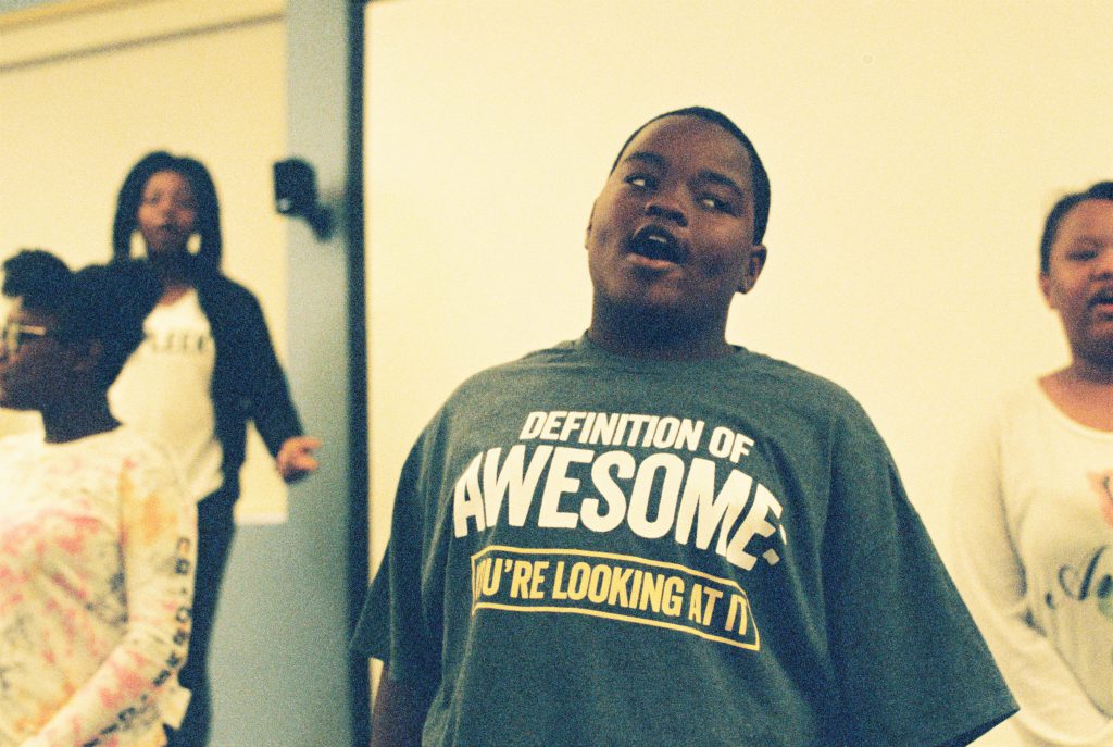 Image: At the BBF Family Services open house in June, a young person's shirt reads, "Definition of Awesome: You're looking at it." Photo by Eric Roberts.