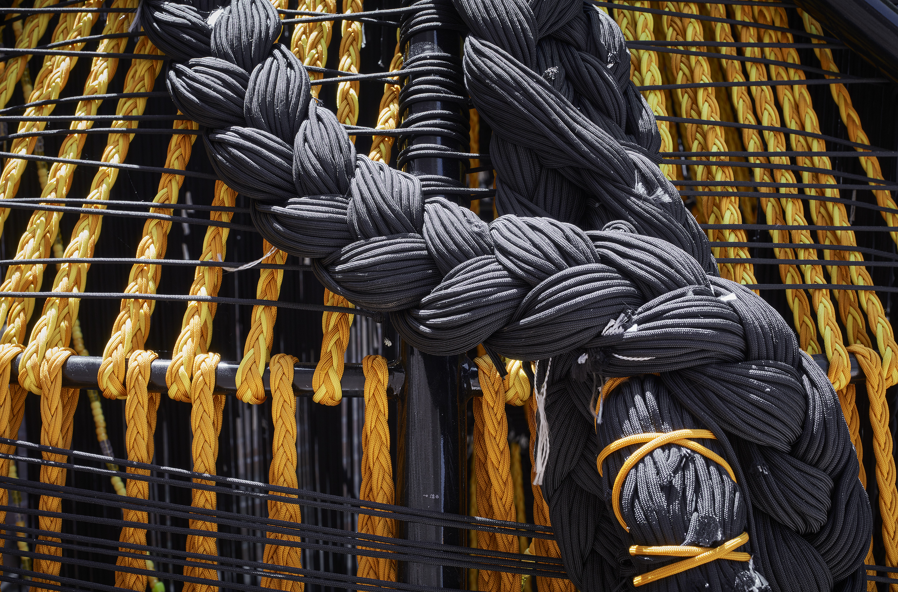 Image: Detail of Thrival Geographies (In My Mind I See a Line) by Amanda Williams + Andres L. Hernandez, in collaboration with Shani Crowe at the 2018 U.S. Pavilion. The image shows a further detail of the outer structure, focusing on two large braids falling along the exterior. Photo © Tom Harris. Courtesy of the School of the Art Institute of Chicago and the University of Chicago.