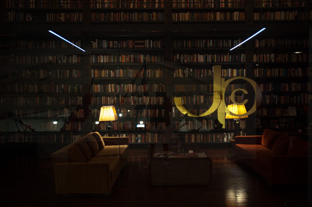 Image: The Johnson Publishing Company's logo etched into the glass wall of "The Johnson" reading room and lounge, housing thousands of books, artwork, and original furnishings from the company's archive included in A Johnson Publishing Story exhibition. Photo by Tony Smith.