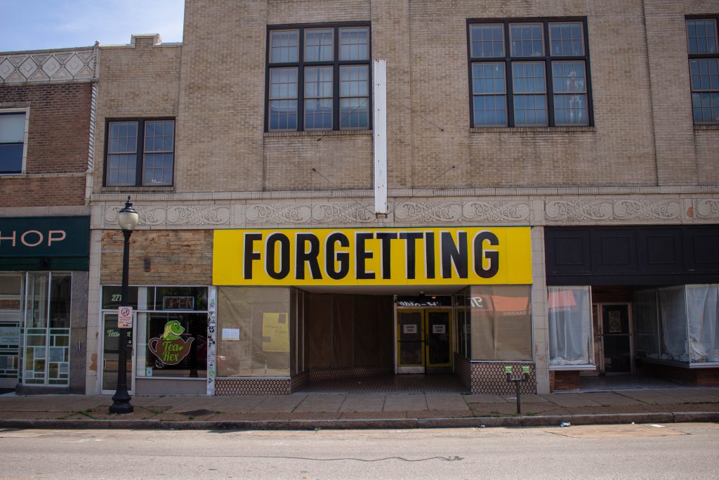 Image: Joseph del Pesco and Jon Rubin, Monuments, Ruins and Forgetting; 2019. Installation with changing signpainting. A vacant storefront with a large yellow sign that reads "Forgetting." Photo by Shabez Jamal. Photo by Shabez Jamal. 
