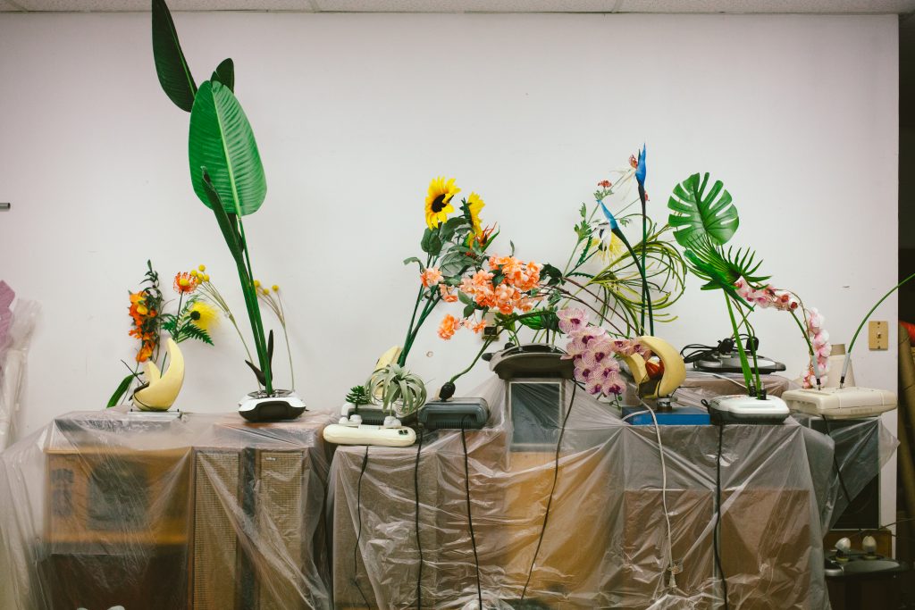 Rachel Youn, Untitled, 2020. Massagers, artificial plants, and speaker cabinets. Photo by Krista Valdez. 