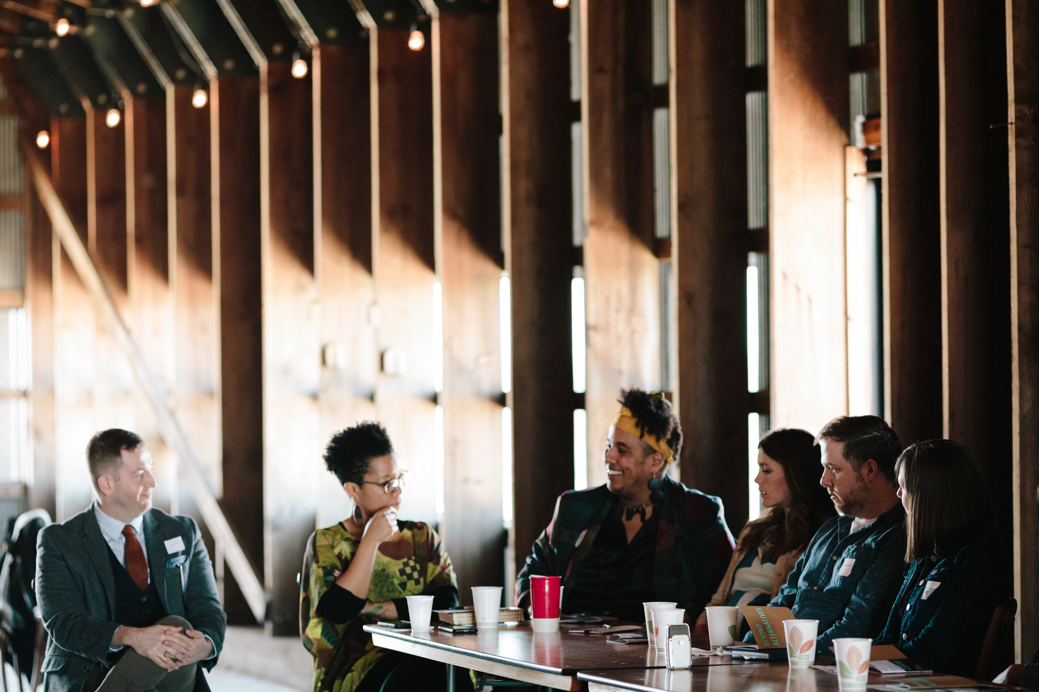 This is an image of moderators and panelists talking.