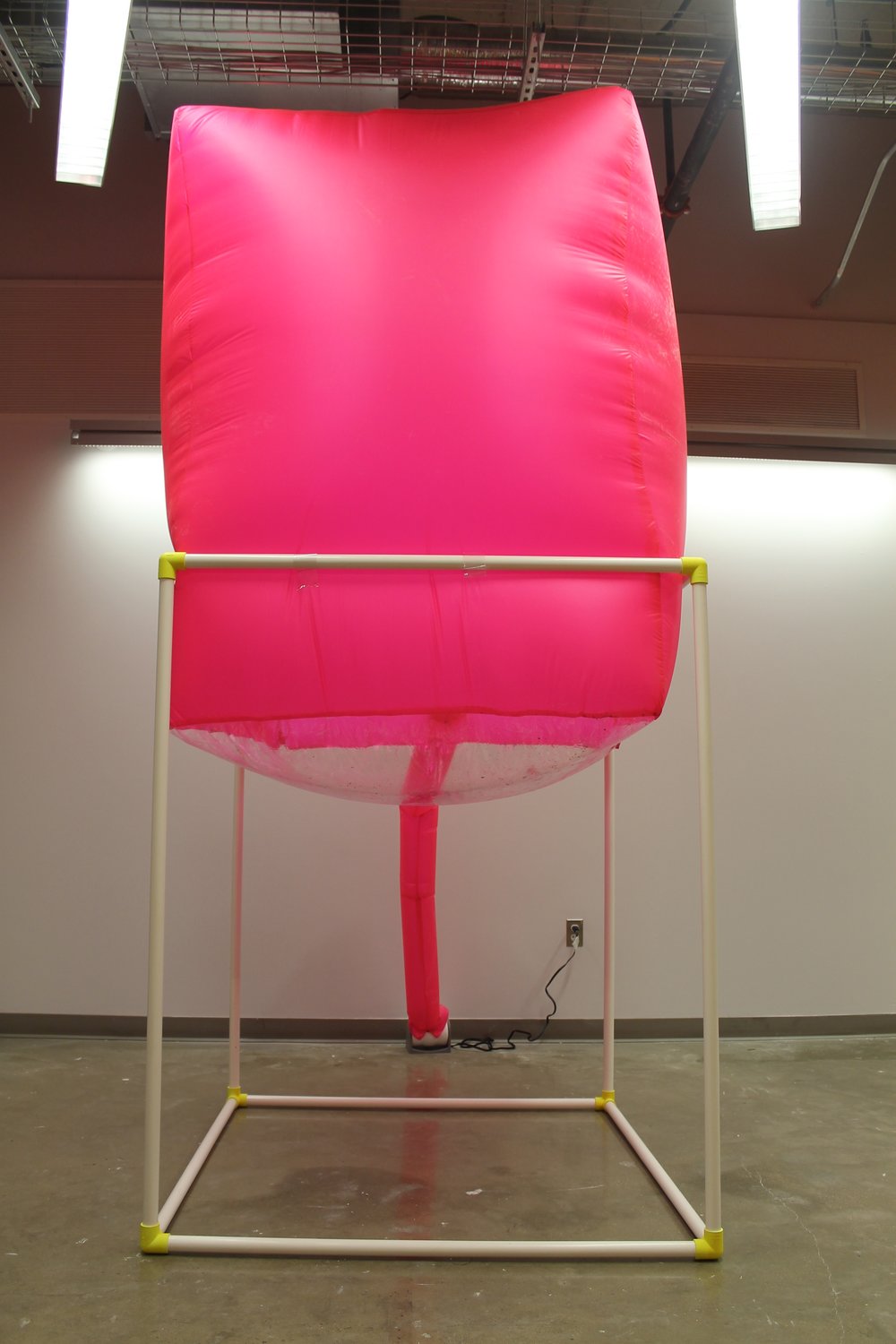 Image: a large pink inflated cube sits atop a white PVC structure. "Negotiating Space: Othered by Design" by Bri Beck, courtesy of the artist.