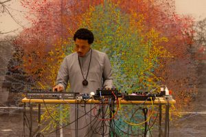 Brotha El spinning at the Smart Museum in front of Charles Gaines' Numbers and Trees, Central Park, Series I, Tree #9, 2016. Photo by Cecil McDonald.