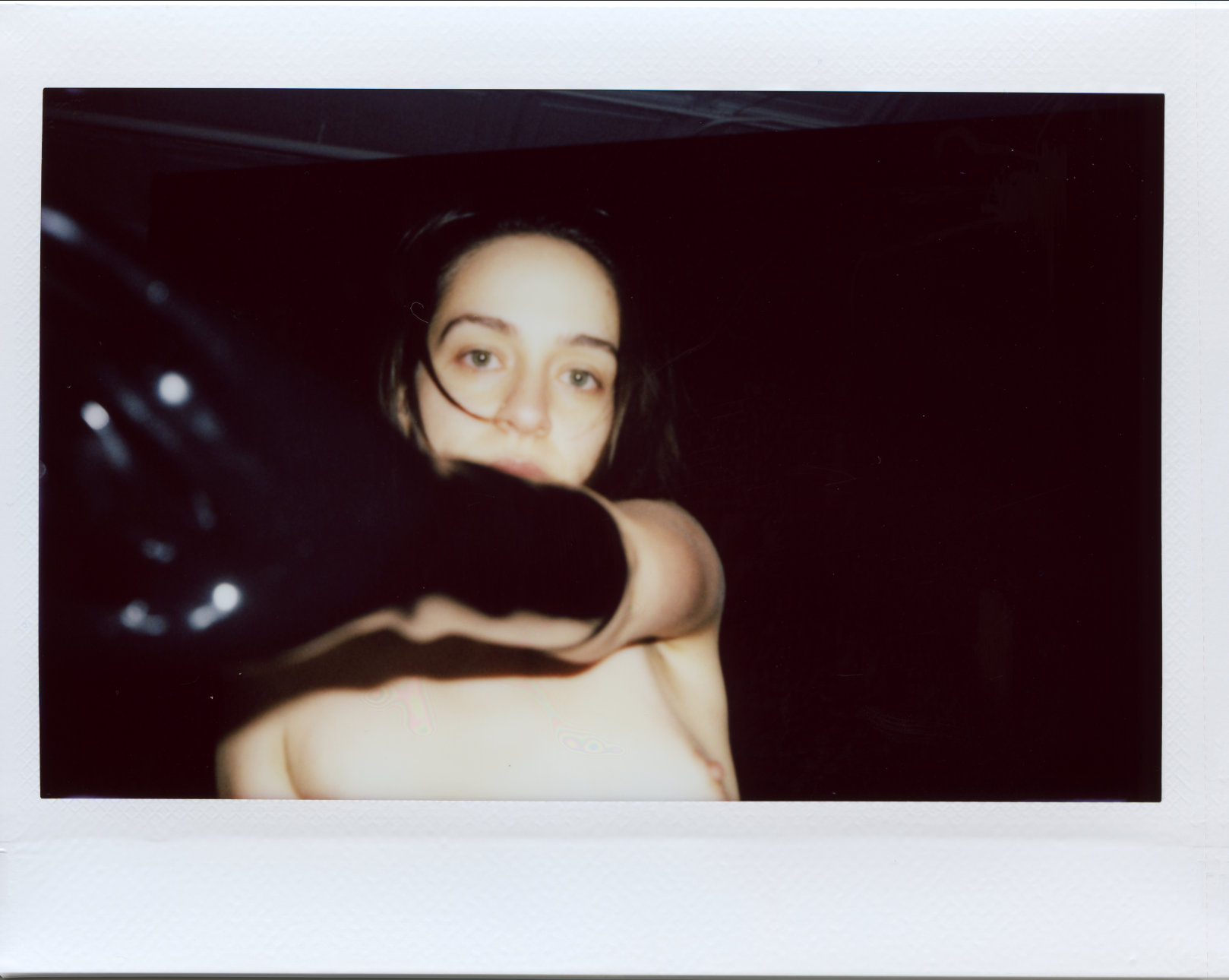 Image: Jasmine Mendoza's black-gloved hand reaches toward the camera in a Polaroid portrait.