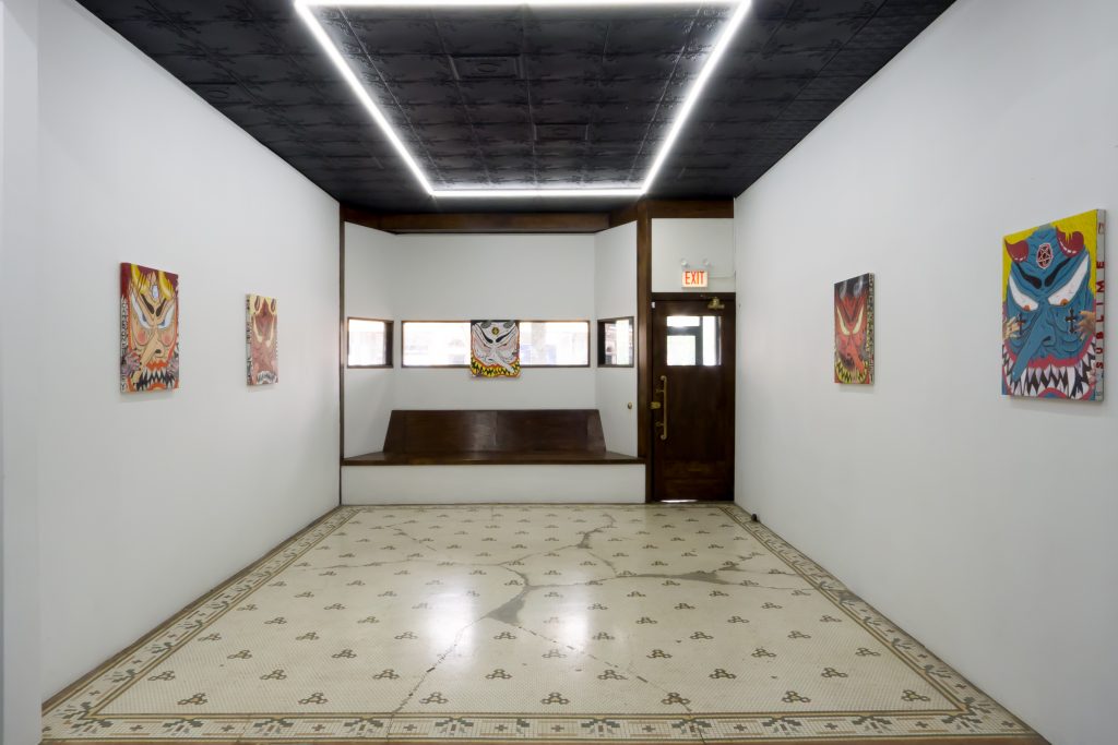 Image: An installation view of Cameron Spratley's exhibition 740 at M. LeBlanc. The image shows a view looking of the gallery space looking straight back towards the front door. Paintings from Spratley's series Devils hang on the wall. Image courtesy of M. LeBlanc.