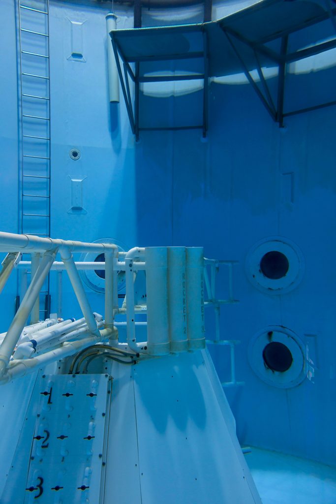 Image: Neutral Buoyancy Simulator, 2019 by Barbara Diener. The image shows a neutral buoyancy simulator tank at the U.S. Space and Rocket Center in Huntsville, AL. The tank is completely blue (various shades). Image courtesy of the artist.