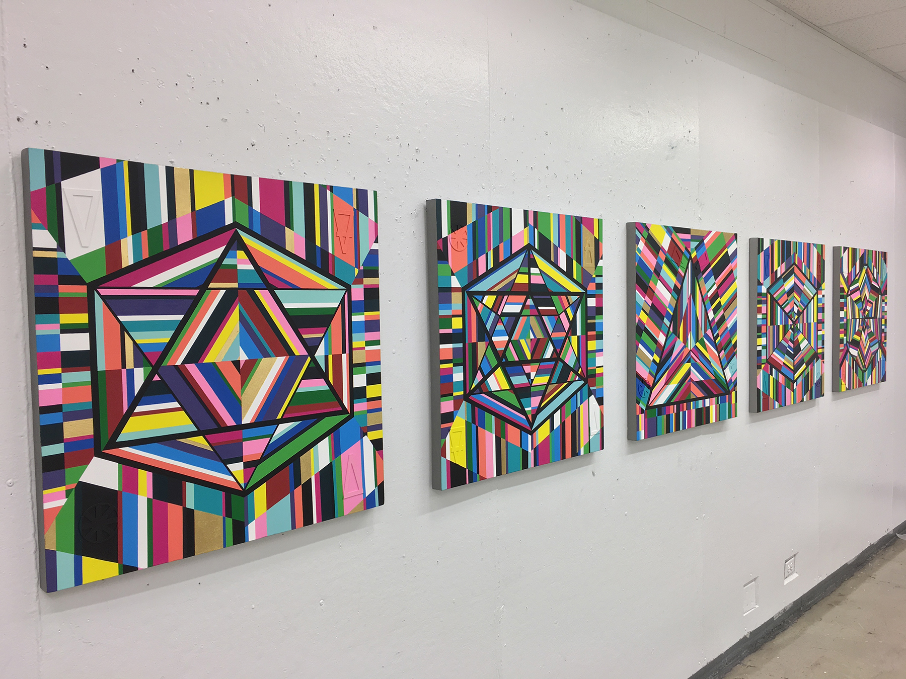 Image: “5 Platonic Solids” painting series by Kristoffer McAfee. A view of five mixed media paintings, (acrylic paint, illustration board, and gold foil) on canvas, 30”x30” each. Image courtesy of the artist.