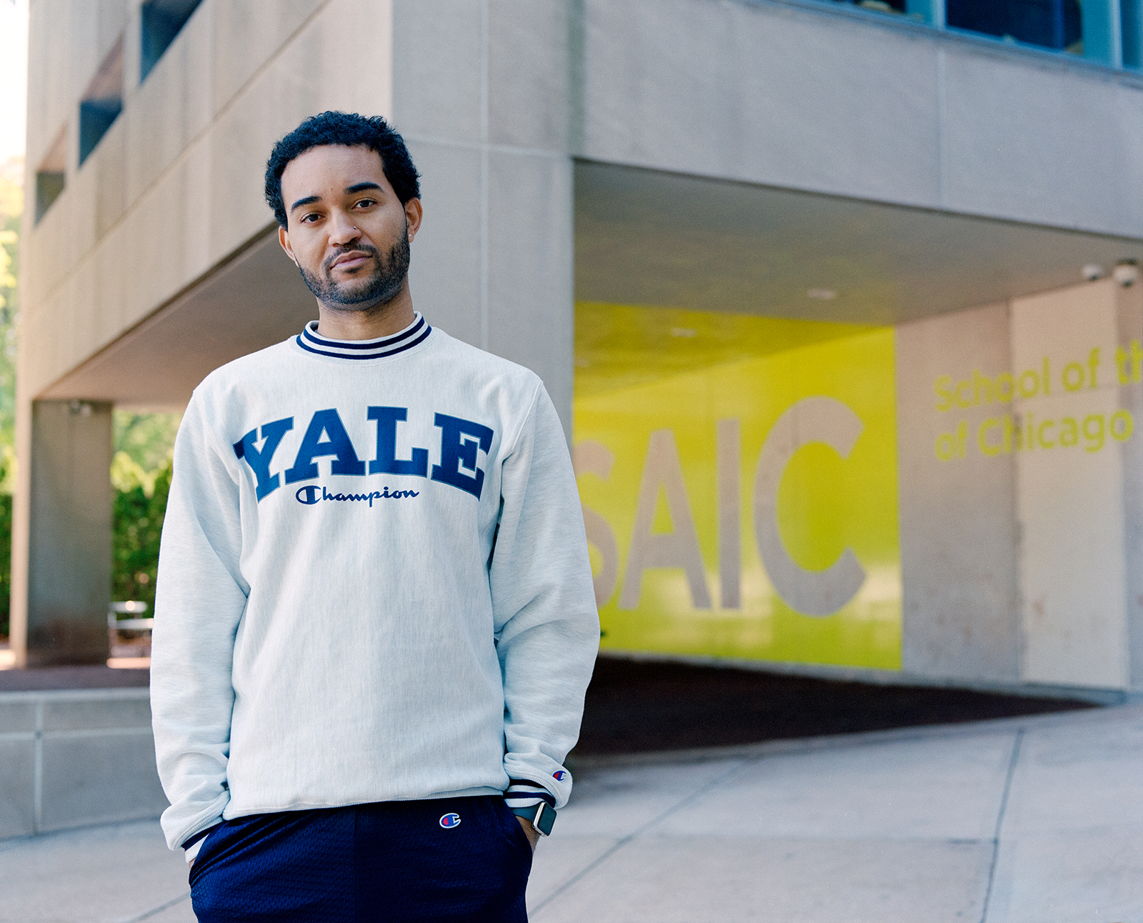 Image: Kristoffer McAfee stands outside the School of the Art Institute Columbus building, where the painting students spend most of their time. He says his experience at SAIC “gave me confidence in my work and direction.” Photo by Kristie Kahns.