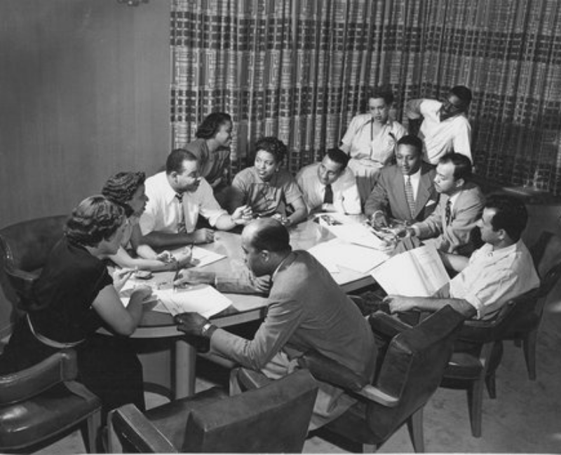 Ebony Magazine Editorial Meeting, Freda DeKnight, Publisher John Johnson, Editor Ben Burns, Leroy Wimbush, taken in their offices in a converted funeral parlor, Chicago, Illinois.