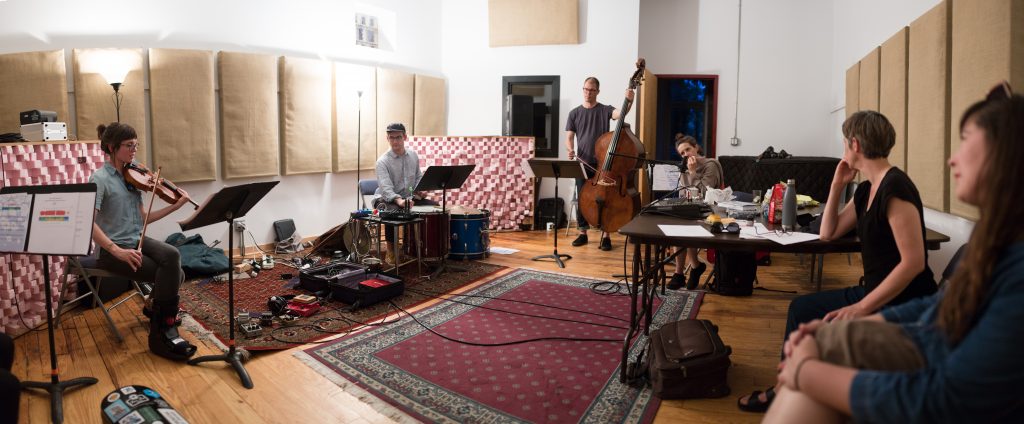 Image: The White Wanderer group rehearsing 'Requiem: A White Wanderer' in a studio at ESS, composed by Katherine Young and created in collaboration with Luftwerk. Image courtesy of Experimental Sound Studio.