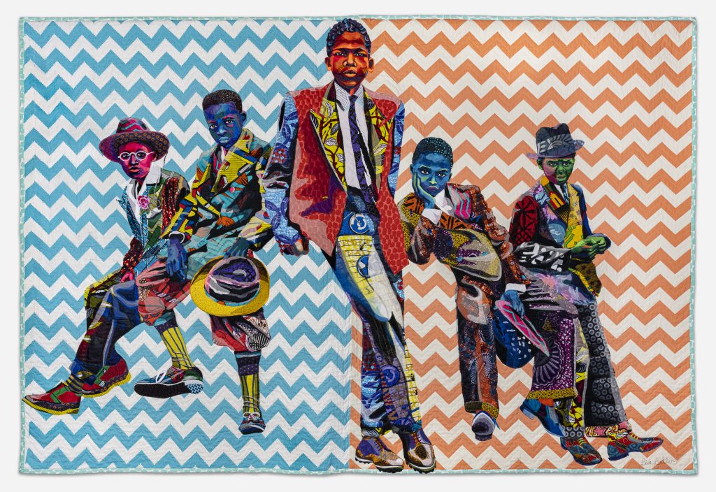 Image: Bisa Butler. Southside Sunday Morning, 2018. Private collection. © Bisa Butler. The textile piece portrays five boys in various stances, as if leaning on an invisible car. Their clothes are all colorful with various patterns. The background is zig-zag striped with white and blue on the left side, and white and orange on the right. Photo by Margaret Fox. Image courtesy of the Art Institute.