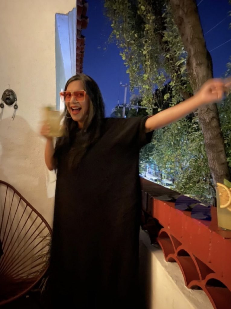 Image: A photo of Nandini Khaund standing in front of a window.