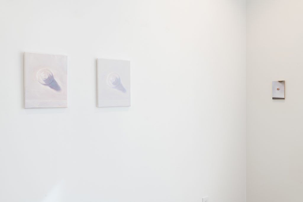 Image: Brendan Getz, installation view of Usual Objects. (l) Painted building bolt and a barycentric view, 2021. Oil on stretched canvas, 14 x 11 inches, each. (r) penny painting and the counter plane, double glint in the window light, 2021. Oil on clayboard, 7 x 5 inches. Image courtesy of the artist and Carrie Secrist Gallery.