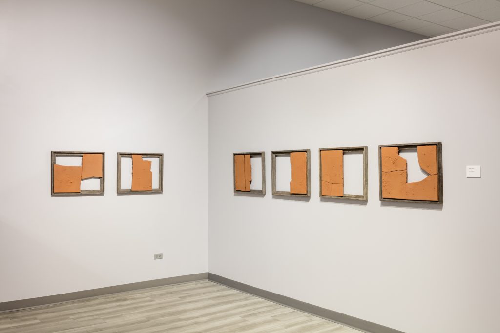 Image: Broken Whole, 2021 by Gunjan Kumar. Clay. Six wooden frames are each filled with pieces of broken clay in different configurations; the voids have an equal visual importance and presence. Photo Credit: Jonathan Castillo, Courtesy of South Asia Institute.