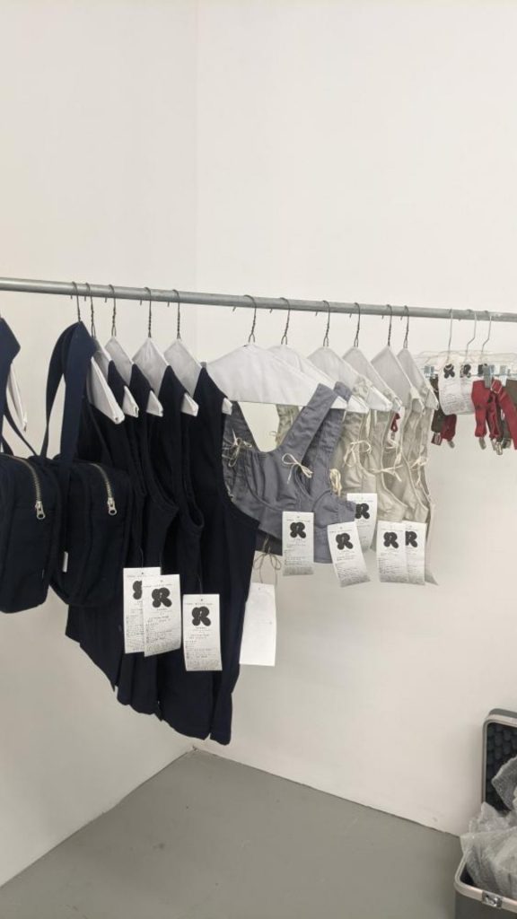 Image: A rack of garments by Chicago designer Olivia Rehm at a pop-up at Consulting Group at Mana Contemporary. Image courtesy of the designer.