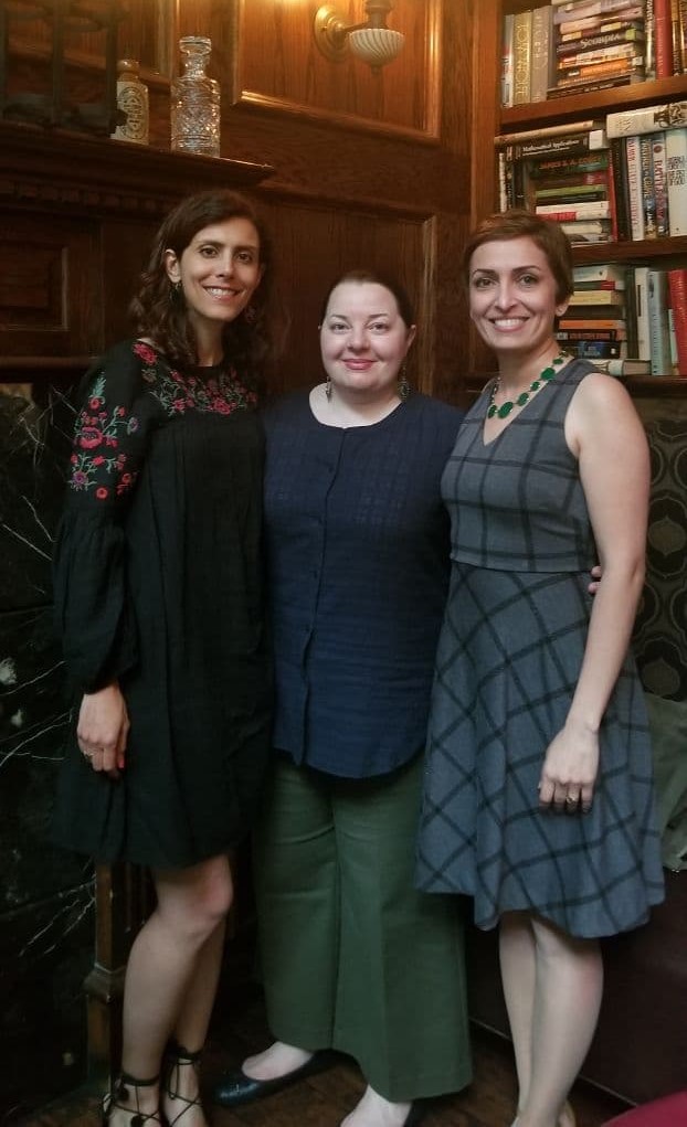 Image: Didaar Art Collective in Summer 2018, From Left to Right: Yasaman Moussavi, Leili Adibfar, and Azadeh Hussaini. The three stand in front of a book case and smile at the viewer. Courtesy of Didaar Art Collective.