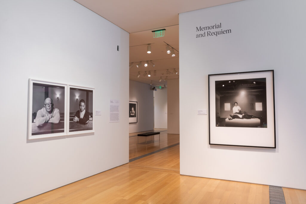Image: Installation view of Dawoud Bey & Carrie Mae Weems: In Dialogue at the Grand Rapids Art Museum. The image shows several black and white photographs in the foreground hung on white walls. The two on the left are from Bey's The Birmingham Project, and the one on the right is from Weems' series Constructing History: A Requiem to Mark the Moment. Courtesy of the museum.