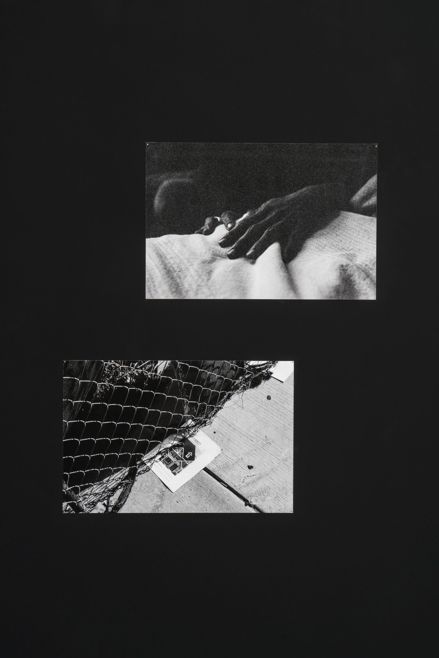 Image: A detail shot of two black and white photographs by Abigail Taubman. The top image is of a hand touching fabric, and the bottom image shows a piece of paper stuck under a fence. Photo by Robert Chase Heishman.