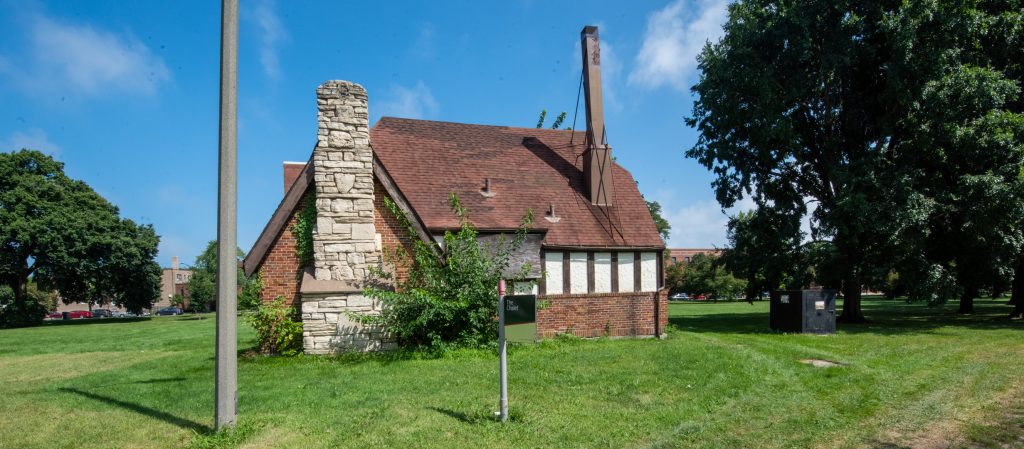 Image: A structure called The Chalet sits on a manicured lot with trees and modern structures in the background. Photo by EdVetté Wilson Jones.