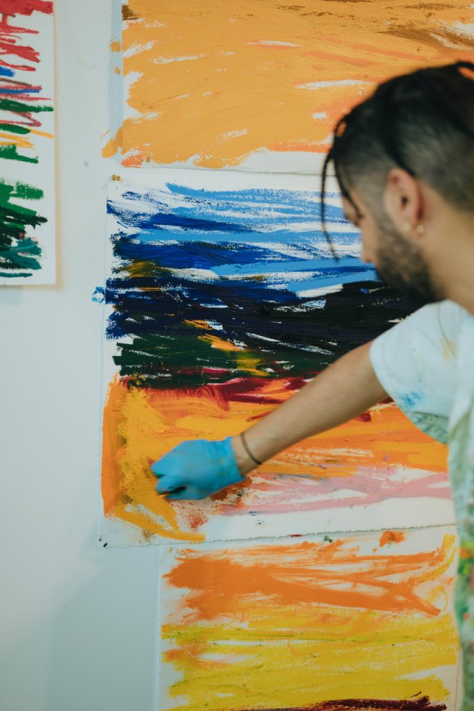 Image: Paul Verdell using oil pastels to create his abstract work in his studio. Photo by Kai Newby. Image courtesy of the artist and Library Street Collective. 
