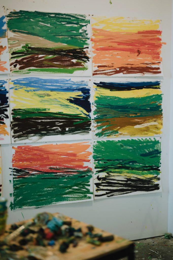 Image: A grid of six abstract oil pastel works on paper can be seen hanging on a wall in Paul Verdell's studio. Photo by Kai Newby. Image courtesy of the artist and Library Street Collective. 