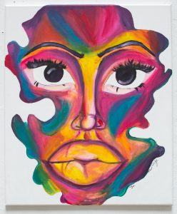 Image: In this painting by Saidayah Kirk, a colorful, abstracted, and amorphous portrait of a face takes up the entirety of a rectangular canvas. The facial features are emphasized and fade in and out of a rainbow spectrum of colors. Photo by Kristie Kahns.