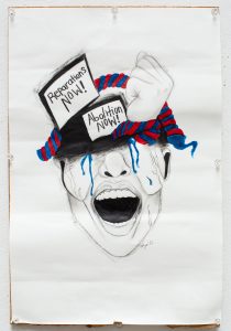 Image: In this mixed media drawing by Saidayah Kirk there is a sketch of a face shown from the nose down, that appears to be shouting. Covering its eyes and along its head are signs that read "Reparations Now!" and "Abolition Now!", surrounded by a fist and spirals of red and blue. Photo by Kristie Kahns.