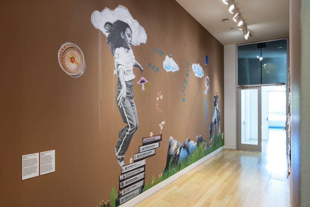 Image: Installation view, Krista Franklin and Gloria “Gloe” Talamantes, Lift Off, 2022. Young girl in the clouds with a UFO and a yo-yo. Courtesy of DePaul Art Museum.