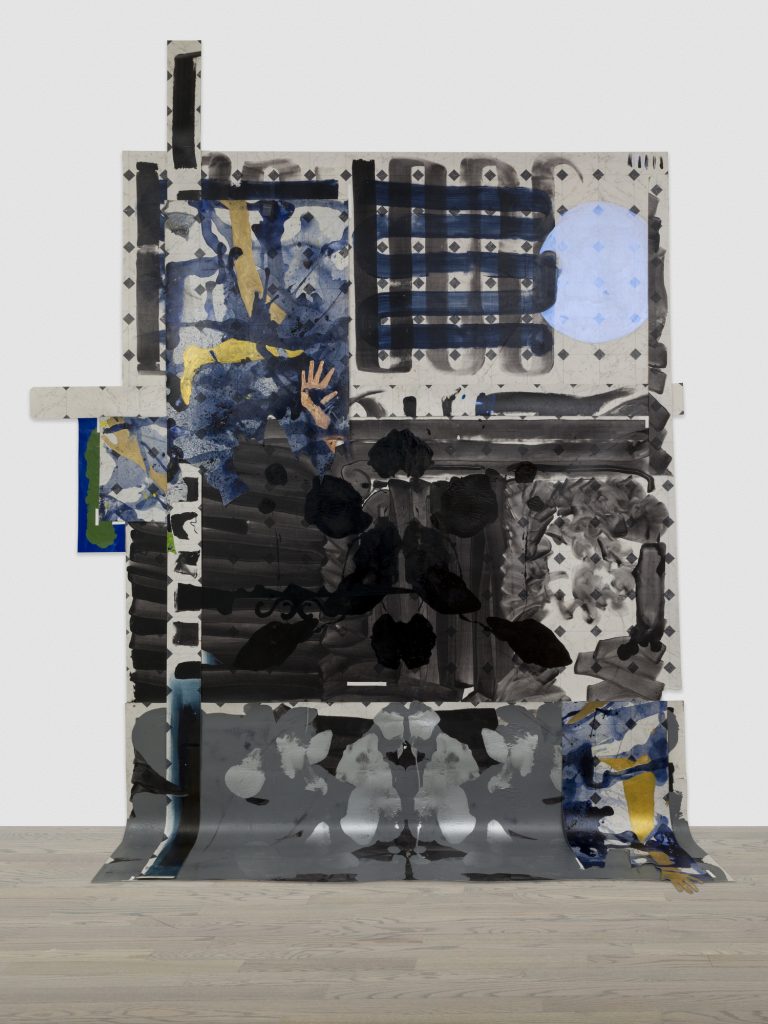 Image: Installation view of the piece "Arena 00". The piece is large, with dark blues, black, grays, and gold across the canvas and linoleum. The piece drapes down and onto the floor. Photo courtesy of the artist. Photo by Evan Jenkins.