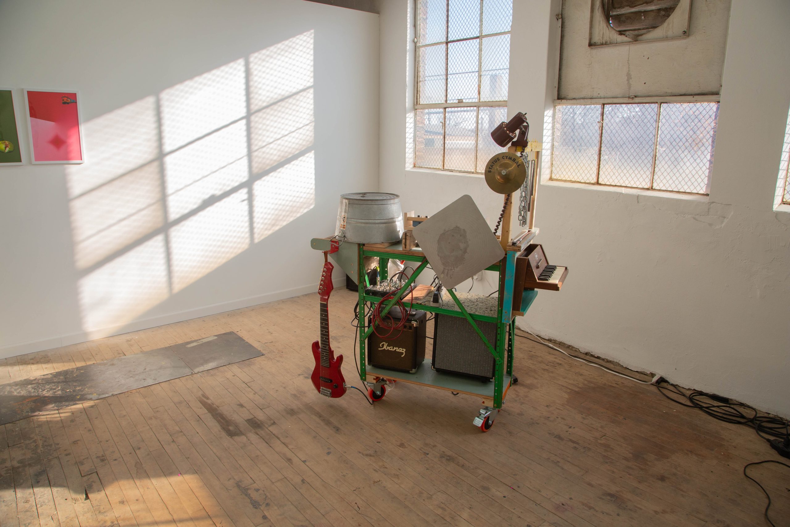 Image: Madeleine Aguilar, "Mobile Music Maker iii," 2022. A rolling cart is filled with an assortment of instruments, including a guitar, keyboard, and speaker, as well as handmade chimes, a drywall scraper, rulers, and found wood. Image courtesy of the artist and The Plan.