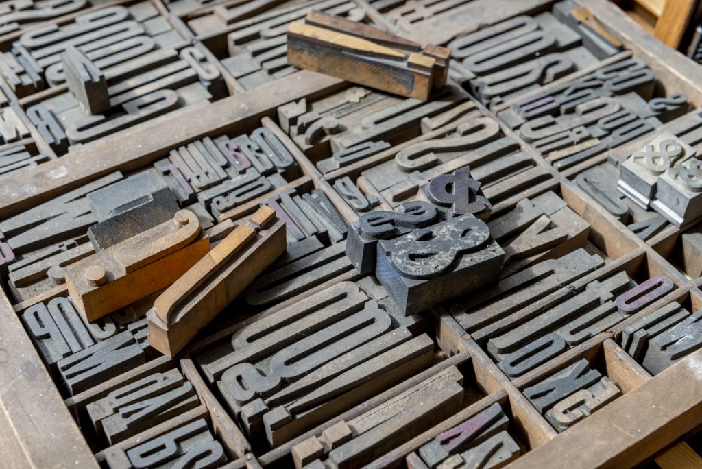 Image: Close-up of Ben Blount's wood letter collection. Photo by Ryan Edmund Thiel.