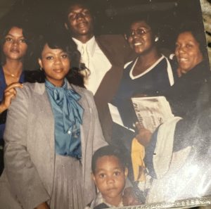 Image: Green family members pose for picture. Vanita Green wears navy in the back row of family members at her brother's graduation (approx. 1979). Image courtesy of the Green family.