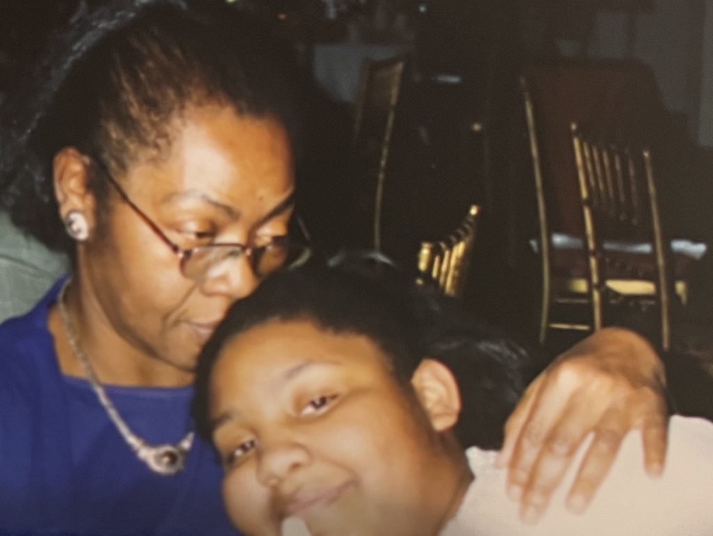 Image: Close up shot of Vanita embracing Carmen, her youngest daughter, circa 1991. Image courtesy of Green family.