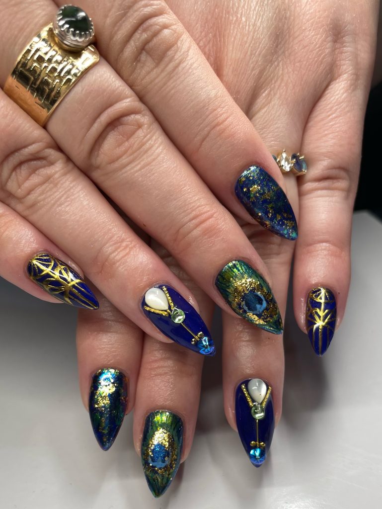 Image: Elaborate manicure featuring blue and gold nail art by Imagine Uhlenbrock. Courtesy of Just Imagine Nails