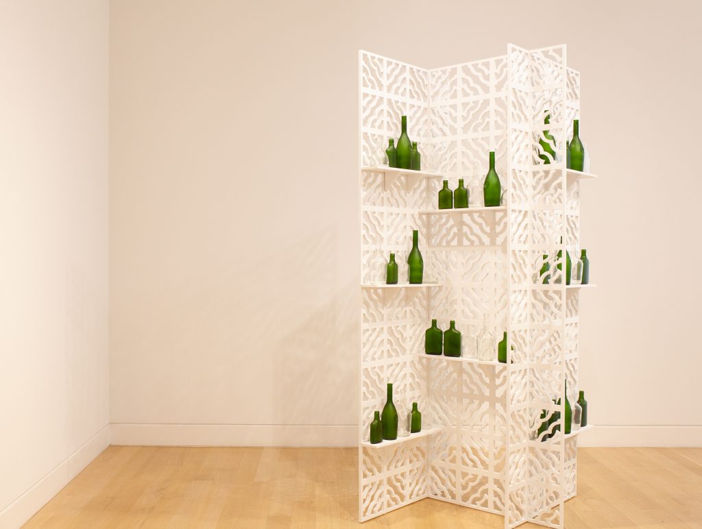 Image: Edra Soto, Open 24 Hours, 2018. Green glass bottles arranged on a lattice screen made of medium-density fiberboard. Image courtesy of DePaul Art Museum, Art Acquisition Endowment Fund.