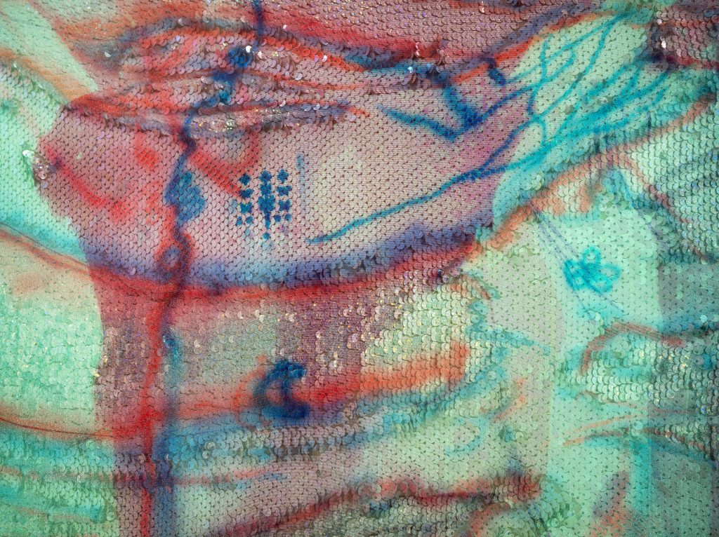Image: Detail of Yae Jee Min's Regrowth, Rebirth, Wings, 2022. Sequins, nail polish, heatpress dyes on polyester, graphite, acrylic, Angelina fibers, glitter, and ink. 48"H x 24"W. The piece is largely abstract with red blue gestural marks on a bright green background. Photo by Dabin Ahn.