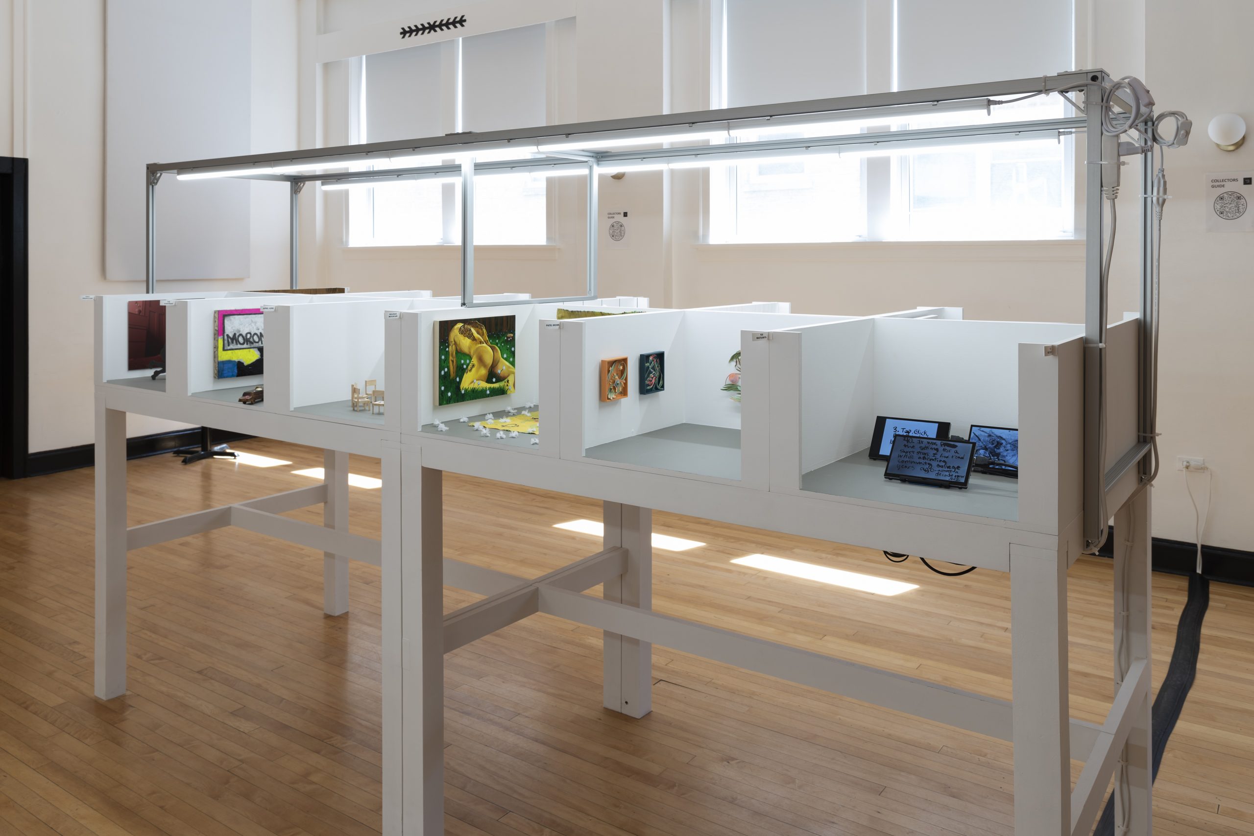 Image: An installation view of booths at Barely Fair at Color Club. Photo by roland miller.