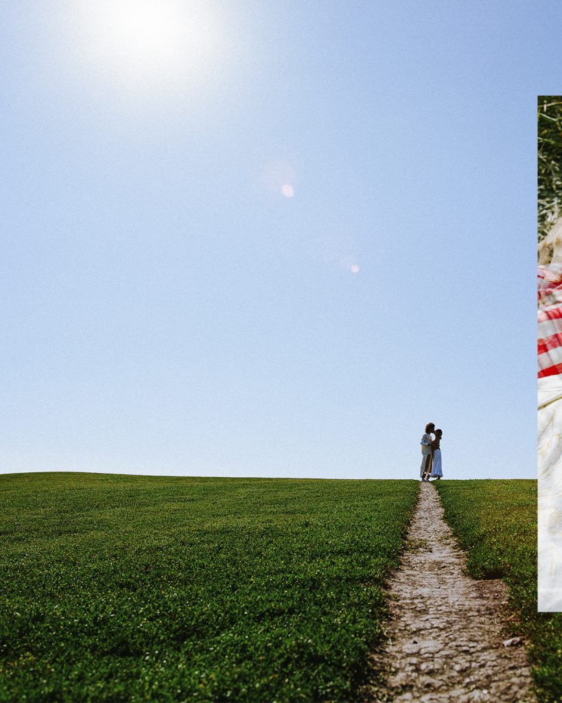 Image: Antonio and Francine are seen in the distance, against a clear blue sky and at the end of a trail that cuts through a green grassy field. Photo by Steven Piper.