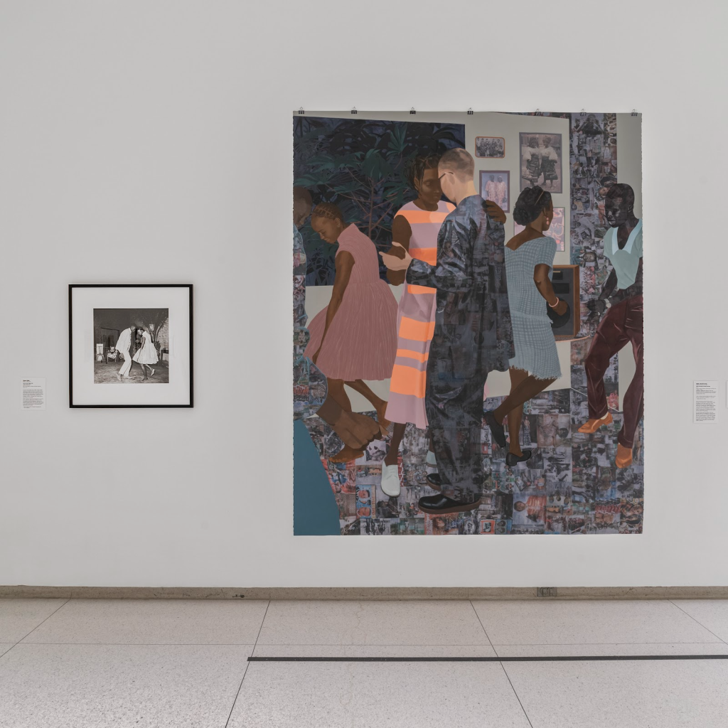 Image: A white gallery wall contains a small black and white image next to a large, colorful mixed-media painting depicting a dance scene on top of collaged surfaces. Installation view, not all realisms: photography, Africa, and the long 1960s, Smart Museum of Art, The University of Chicago. Photo by Robert Chase Heishman. Works pictured (left to right): Malick Sidibé, Nuit de Noël (Happy Club), 1963, printed 2002, Gelatin silver print. Smart Museum of Art, The University of Chicago, Gift of the Estate of Lester and Betty Guttman, 2014.720. Njideka Akunyili Crosby, When the Going Is Smooth and Good, 2017, Acrylic, solvent transfer, colored pencil, charcoal and collage on paper. Collection of the Solomon R. Guggenheim Museum, New York.