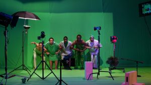 Image: Performers from [siccer] stand arm and arm facing the camera. Performers pictured from left to right: Holland Andrews, jess pretty, Katrina Reid, keyon gaskin, Jeremy Toussaint-Baptiste. The picture was taken at Experimental Media and Performing Arts Center by Will Rawls. Courtesy of Will Rawls and the Museum of Contemporary Art Chicago.