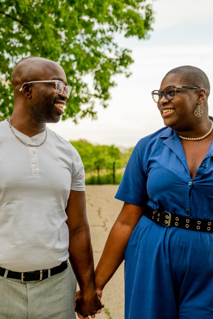 Image: Josey and Johnny hold hands and smile at each other. Photo by Tonal Simmons